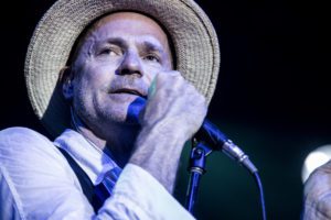 Gord Downie with a microphone in his hand