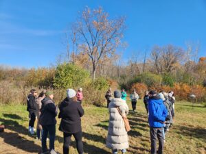 Adults gathered in a circle outdoors.